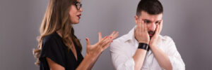 A woman argues with a man, whose body language shows exasperation.